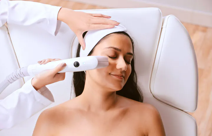 Sofwave treatment photograph, Square Mile Clinic, City of London Sofwave handpiece on the cheek, skin firming available at Square Mile Clinic, City of London